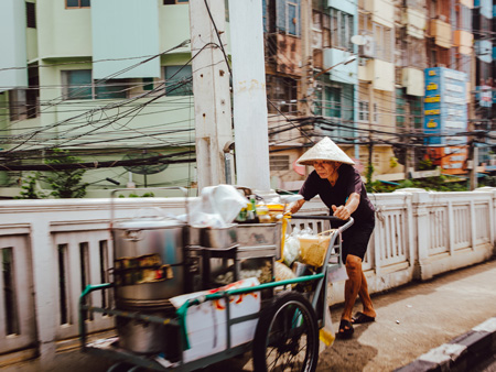 Man pushing a food cart