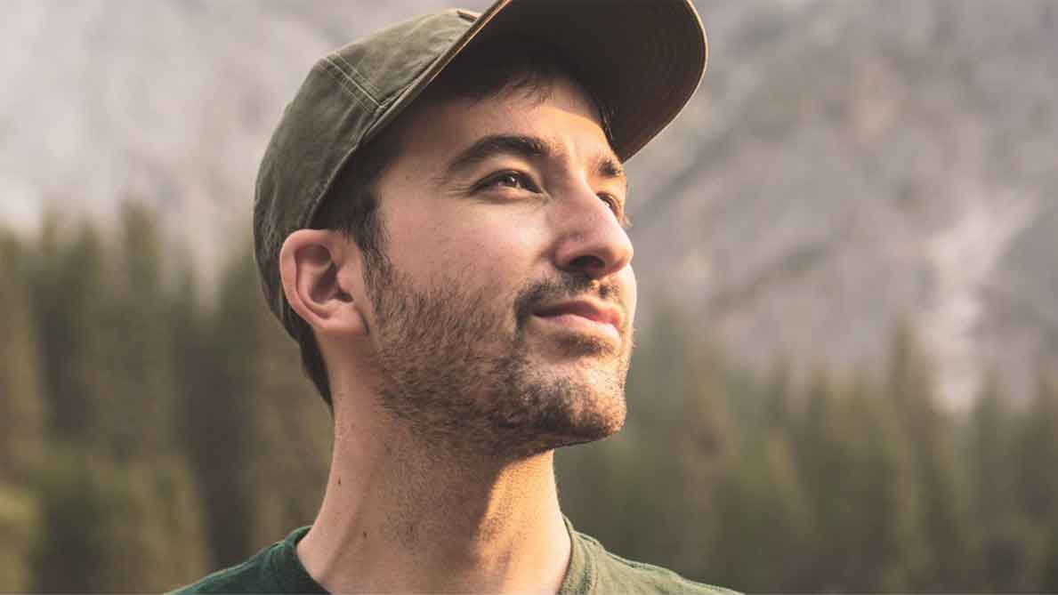 A photo of a man in green shirt and cap