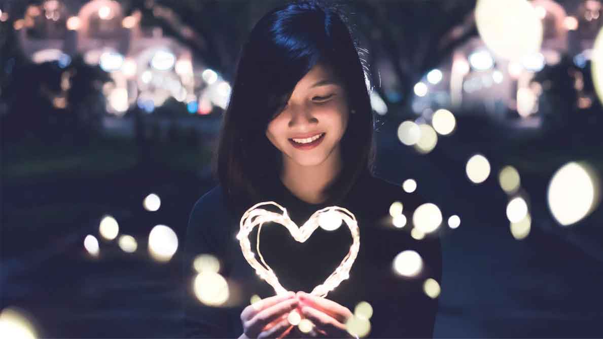 Asian woman holding heart